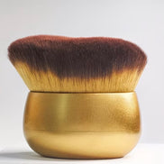 Deluxe Kabuki Brush with a gold handle and dense brown and golden bristles