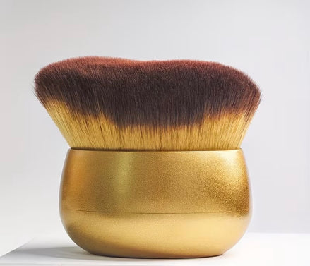 Deluxe Kabuki Brush with a gold handle and dense brown and golden bristles
