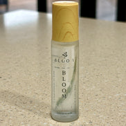 Bloom perfume oil 15 mL roll-on with wooden cap photographed on a countertop