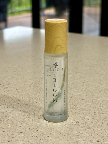 Bloom perfume oil 15 mL roll-on with wooden cap photographed on a countertop