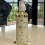 Bloom Botanical Body Oil 100 mL with white pump and botanical label photographed on a countertop