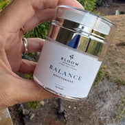 Balance Moisturiser 50 mL held in a hand outdoors