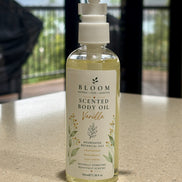 Vanilla Botanical Body Oil 100 mL with white pump and gold botanical label photographed on a countertop