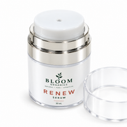 Close-up of the Renew Serum airless dispenser with its clear lid beside it
