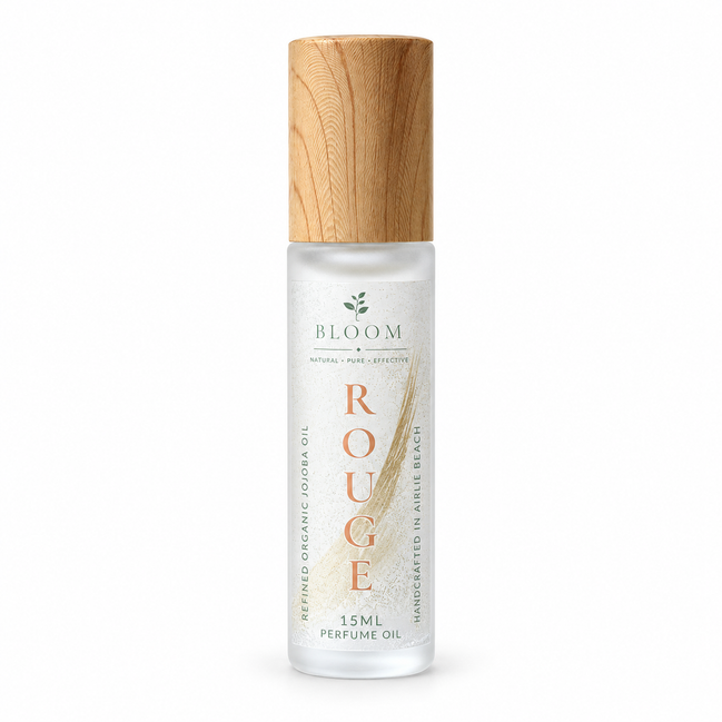 Rouge perfume oil 15 mL roll-on with wooden cap on a white background