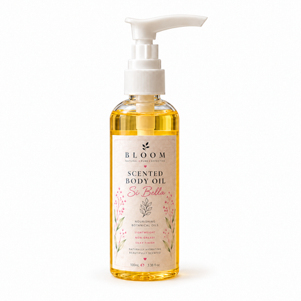 Si Bella scented body oil 100 mL in a clear bottle with white pump and golden oil on a white background